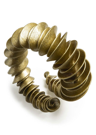 Gold spiral bracelet on a white background