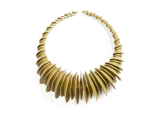 Gold necklace with a unique design on a white background