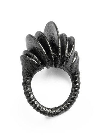 Black ring with unique design on a white background