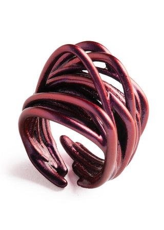 Red metal ring with a twisted design on a white background