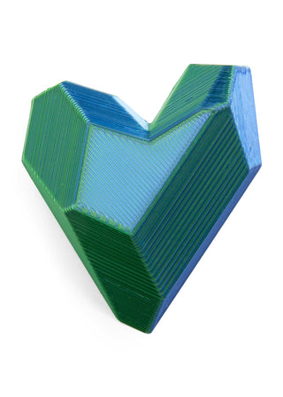 Geometric heart-shaped object with blue and green colors on a white background