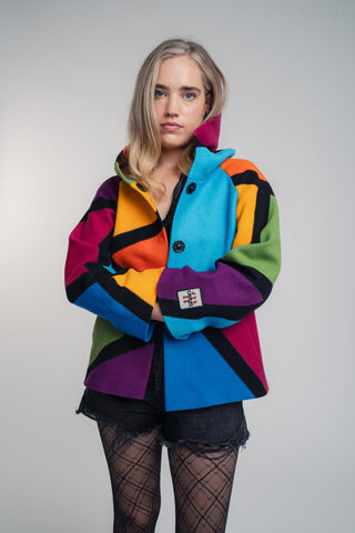 Discover our handcrafted abstract multi-color hooded jacket made of premium Burel wool. Each piece features a unique pattern, expert tailoring, and vibrant style. Perfect for bold fashion lovers.
