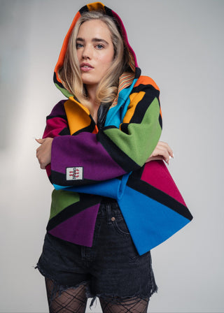 Discover our handcrafted abstract multi-color hooded jacket made of premium Burel wool. Each piece features a unique pattern, expert tailoring, and vibrant style. Perfect for bold fashion lovers.
