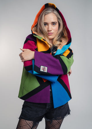 Discover our handcrafted abstract multi-color hooded jacket made of premium Burel wool. Each piece features a unique pattern, expert tailoring, and vibrant style. Perfect for bold fashion lovers.
