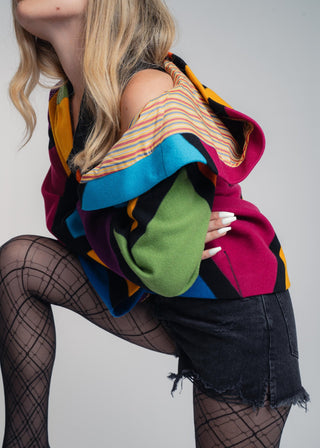 Discover our handcrafted abstract multi-color hooded jacket made of premium Burel wool. Each piece features a unique pattern, expert tailoring, and vibrant style. Perfect for bold fashion lovers.
