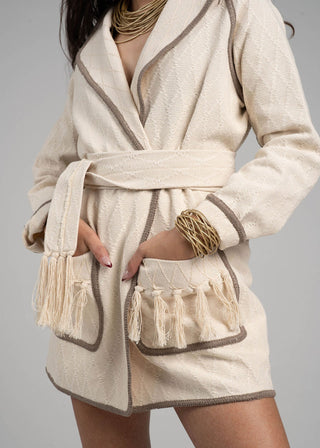 Beige robe with tassels on a gray background