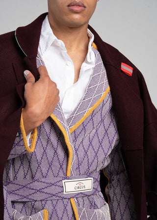 Person wearing a patterned cotton jacket with a visible brand logo against a neutral background