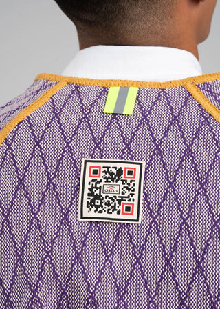 Close-up of a purple textured garment with a QR code label on a gray background