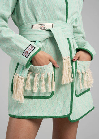 Green textured robe with tassels and 'Circus' branding on a gray background