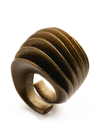 Wooden ring with a spiral design on a white background