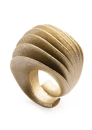 Gold ring with layered design on a white background