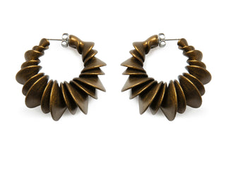 Pair of gold spiral hoop earrings on a white background