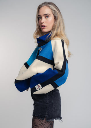 Woman wearing a colorful sweater with a white background