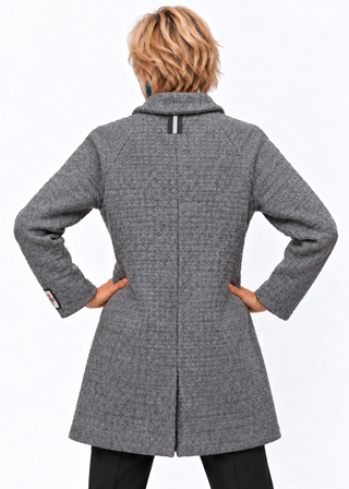 A model shown from the back wearing a textured gray wool-blend coat with black trousers, set against a plain white studio background.