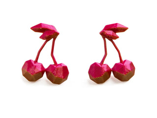 Two 3D-printed pink and brown objects resembling cherries on a white background