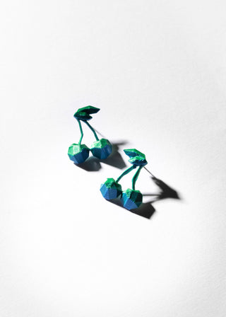 Blue and green plastic toy flowers on a white background