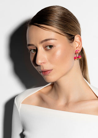Woman wearing a white off-shoulder top with a plain background