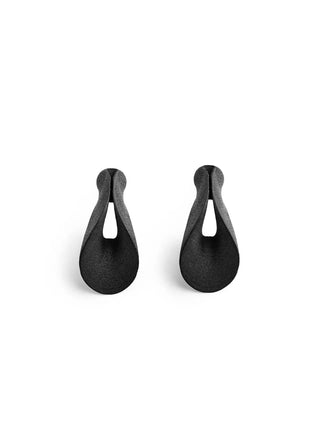 A pair of matte black teardrop-shaped earrings with a central cutout, displayed on a clean white background.