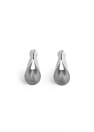 A pair of textured silver teardrop-shaped earrings with a matte finish, displayed on a clean white background.