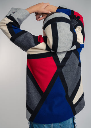 Handcrafted hooded Burel coat made from premium wool. Unique puzzle-cut design, artisan-sewn, sustainable fashion, and timeless style.