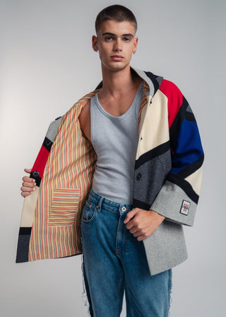 Handcrafted hooded Burel coat made from premium wool. Unique puzzle-cut design, artisan-sewn, sustainable fashion, and timeless style.