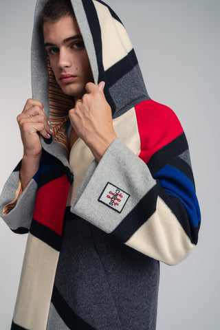 Handcrafted hooded Burel coat made from premium wool. Unique puzzle-cut design, artisan-sewn, sustainable fashion, and timeless style.