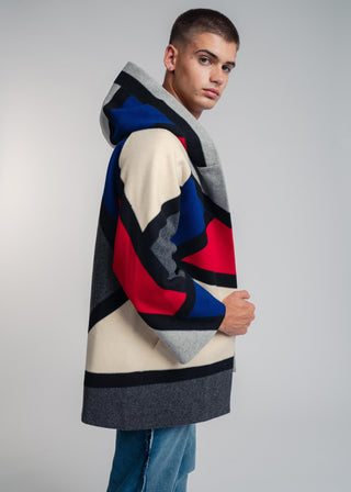 Handcrafted hooded Burel coat made from premium wool. Unique puzzle-cut design, artisan-sewn, sustainable fashion, and timeless style.