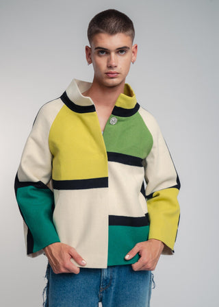 Man wearing a colorful sweater with a plain background