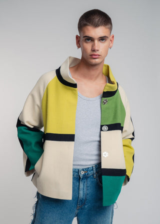 Man wearing a colorful jacket with a plain background