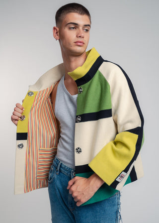 Man wearing a colorful jacket with a neutral background