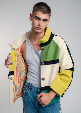 Man wearing a colorful jacket with a plain background