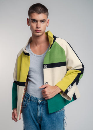 Man wearing a colorful jacket with a neutral background
