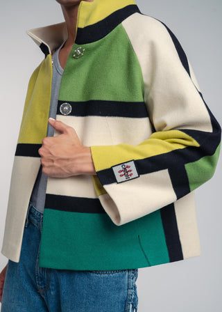 Color-blocked jacket with green, yellow, and beige sections on a plain background