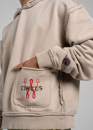 Beige hoodie with a pocket featuring red and black text on a gray background