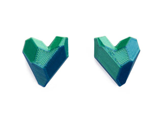 Two green and blue geometric objects on a white background