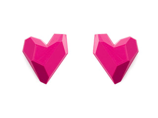 Two pink geometric heart-shaped objects on a white background