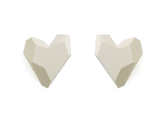Two white geometric heart-shaped objects on a white background