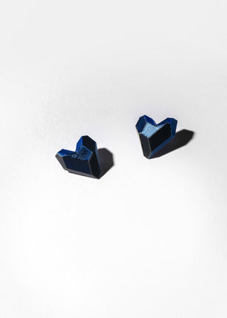 Pair of blue geometric earrings on a white background