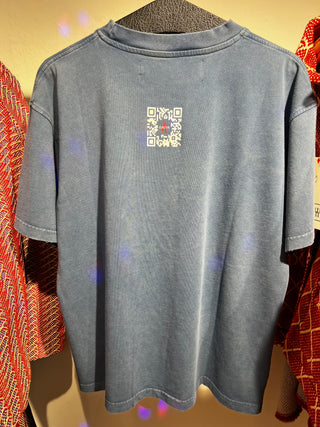 Gray t-shirt with a QR code on a hanger against a colorful background