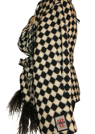 A black and white checkered golf club cover with a small feather accent and a visible 'Sparco' brand tag, displayed on a plain light background.