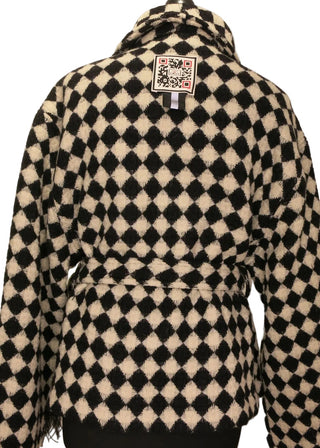 A black and off-white checkered knit sweater displayed on a black dress form mannequin against a plain light background.