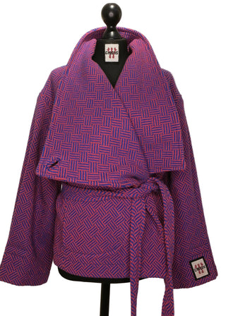 A purple and magenta patterned kimono robe displayed on a black dress form mannequin against a plain beige background.