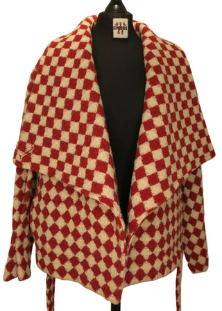 A red and cream checkered jacket displayed on a black mannequin torso against a warm beige background.