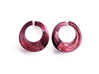 Pair of pink hoop earrings on a white background