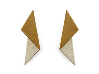 A close-up image of a woman wearing a white and yellow gold colored earring, part of the Maison 203 - Leia 1 Earrings collection.