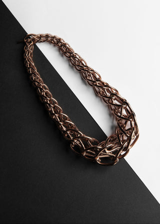 Bronze chain necklace on a black and white background