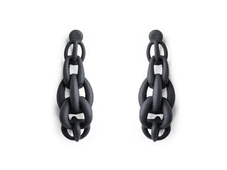 Black chain 3D printed earring worn by a person with dark hair.