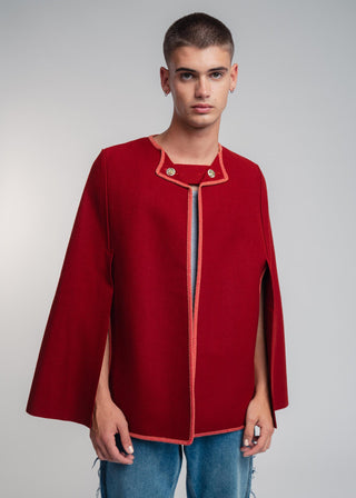 Man wearing a red cape over a gray background