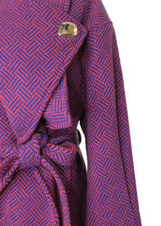 A close-up of a purple and pink patterned fabric accessory, likely a strap or belt, with a small white brand label reading 'CIRCUS' and a silver metal snap closure.