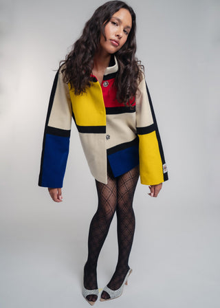 Woman wearing a colorful jacket with a white background